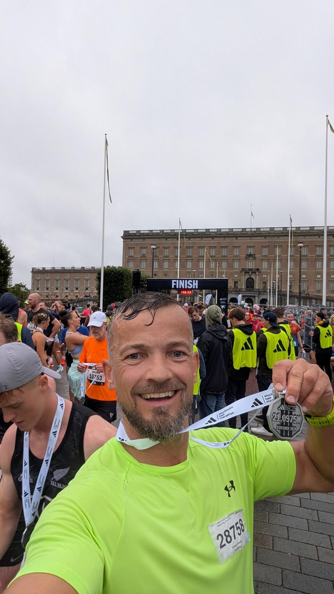 Tomas Smahaj at the Stockholm Half Marathon finish line holding his 2026 finisher medal